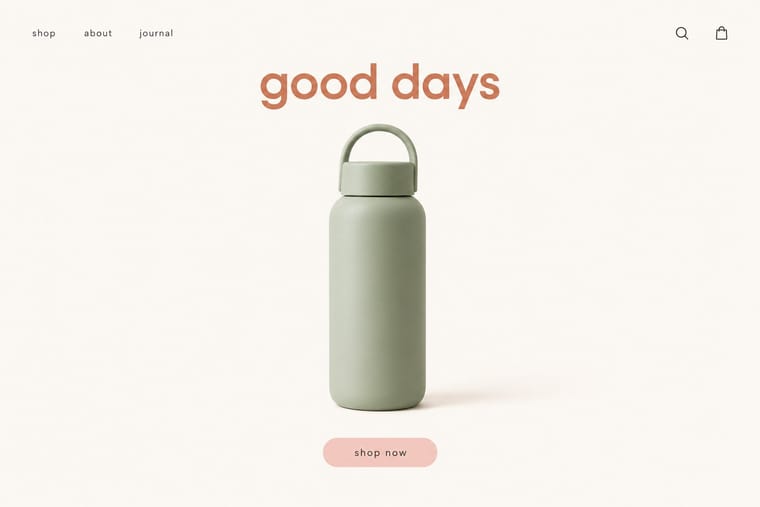 A minimalist shopping homepage shows a sage-green water bottle with a loop handle beneath the large terracotta words “good days” on an off-white background. Small navigation links, search and shopping bag icons, and a pink “shop now” button surround the central product.